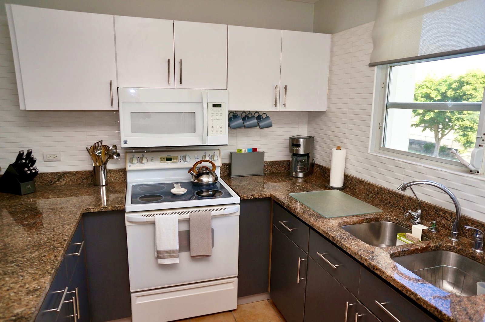 Fully equipped kitchen with stove, microwave, coffeemakers, toaster and more.